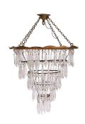 A clear glass and gilt metal basket type light shade: of circular design with prismatic suspensions,