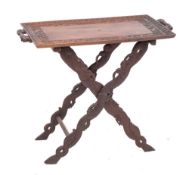 A south east Asian carved and stained hardwood tray on stand, circa 1900,