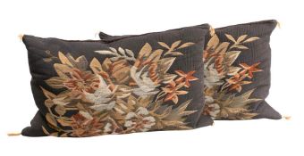 A pair of needlework cushions: decorated with floral sprays worked in browns,