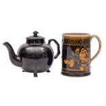 A Jackfield black glazed teapot and cover and a creamware black and brown glazed mug: the teapot of