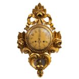 A 20th century gilt-wall clock: the eight-day duration movement striking the hours on a bell,