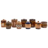 Nine Doulton stoneware tobacco jars: comprising three Natural Foliage Ware examples, two Silicone,