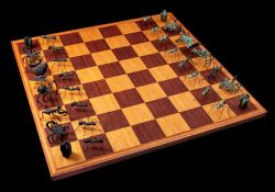 A Laura Sturtz designed bronze insect chess set: one side in natural bronze,