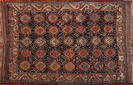 A Quashgai rug:, the indigo field with an all over design of hooked medallions,