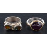 Two gemset rings,: one set with a cabochon-cut, purple,