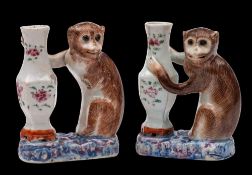 Two rare Chinese famille rose monkey incense holders/candlesticks: each monkey naturalistically