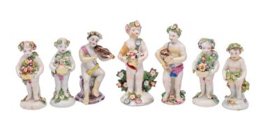 A group of six Bow figures of putti: four holding baskets of flowers,