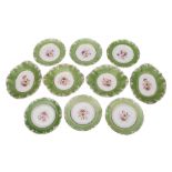 A mid 19th century English pottery botanical part dessert service: each piece painted with a