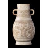 A Chinese pale celadon and grey jade archaistic vase: of flattened baluster form with simple loop