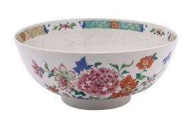A Chinese famille rose bowl: painted overall with peony and other floral sprays,
