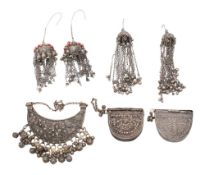 A collection of Middle Eastern silverwares and jewellery: includes two semi-round pouches,