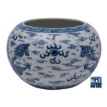 A Chinese blue and white 'Dragon' alms bowl: of globular form with inverted rim,