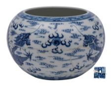 A Chinese blue and white 'Dragon' alms bowl: of globular form with inverted rim,