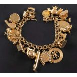 A double-link chain charm bracelet,: stamped '14K', with various charms including a tram,