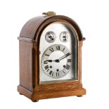 An Edwardian oak Westminster chiming mantel clock: the eight-day duration movement striking the
