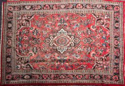A Kashan carpet,: the rose field with a central ivory shaped lozenge pole medallion,