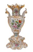 A large 19th Century French 'rococo' moulded vase: in three sections,