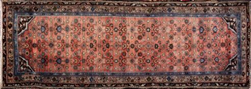 A Caucasian runner:, the brick red field with a geometric floral, foliate and lozenge design,