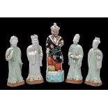 A set of four Chinese celadon glazed figures of Immortals and one other: the bases unglazed,