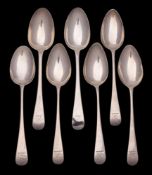 A collection of seven silver Old English pattern dessert spoons, various makers and dates: 227gms,