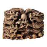 A Chinese carved soapstone seal: of rectangular outline decorated with dragons chasing pearls of