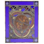 A stained glass panel: the centre decorated with a winged lion,