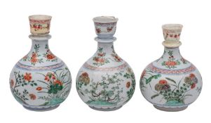 A matched set of three Chinese famille verte hookah bases: with reeded bodies and knopped necks,