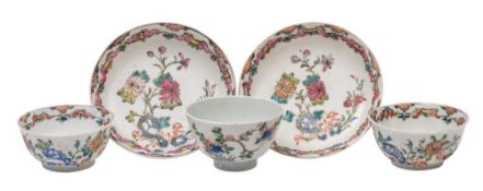 A pair of Chinese famille rose teabowls and saucers and a famille verte teabowl: of eggshell type,