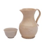 A Staffordshire white saltglaze baluster jug and a similar teabowl: the jug with reeded loop handle,