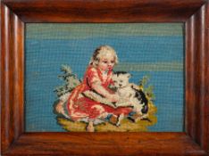 A Victorian woolwork picture: depicting a young girl reading a book with her cat, 21 x 31cm.