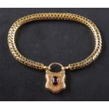 A snake-link bracelet with an engraved cartouche locket clasp,