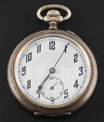 A silver keyless pocket watch: the white dial with stylised Arabic numerals,