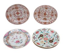 A group of four Chinese famille rose plates and a pair of rouge-de-fer plates,