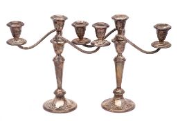 A pair of sterling silver and filled twin branch candelabra,