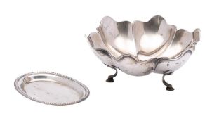 A Portuguese silver bowl, stamped marks: of lobed circular form, raised on three swept feet,