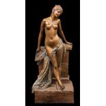 A large Goldscheider Art Nouveau bronzed earthenware figural lamp base: in the form of a semi-naked