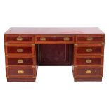 A mahogany veneered and crossbanded pedestal desk, in the style of 19th century campaign furniture,