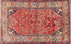 A Saveh rug:, the brick red field with an all over design of birds, palmettes and flowering foliage,