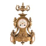 A gilt-metal and porcelain French mantel clock: the eight-day duration movement striking the hours