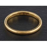 An 18ct gold band ring,: with hallmarks for London, 1954, ring size T, total weight ca. 3gms.