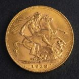 A George V gold sovereign coin, 1919,: diameter ca. 22mms, weight ca. 7.9gms.