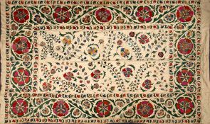 An Indo-Persian wall hanging: the central field with trailing foliage and flowerheads enclosed by a
