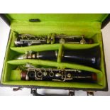 A Boosey and Hawkes four section Regent clarinet: with spare reeds, contained in a fitted case.