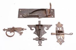 A group of four steel door latches,