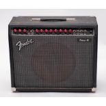 A Fender Deluxe 85 guitar amplifier serial number L097325, with footswitch.