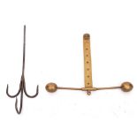 A brass and iron adjustable meat hook: having triple iron spikes on an adjustable brass bar with