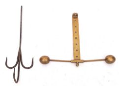 A brass and iron adjustable meat hook: having triple iron spikes on an adjustable brass bar with