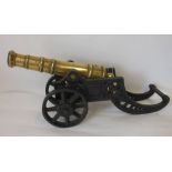 A brass and cast iron model of a cannon: with five stage brass barrel,