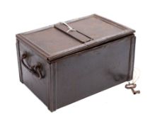An early 19th century iron strongbox: the top with central spring loaded strap cover to keyhole,