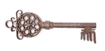 A large antique wrought iron Gothic style key: the 3 inch circular bow with octofoil decoration and